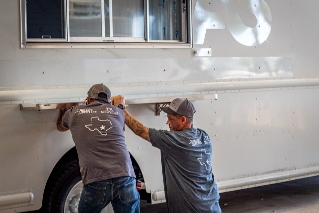 Curbside Upfitters crew working on a build