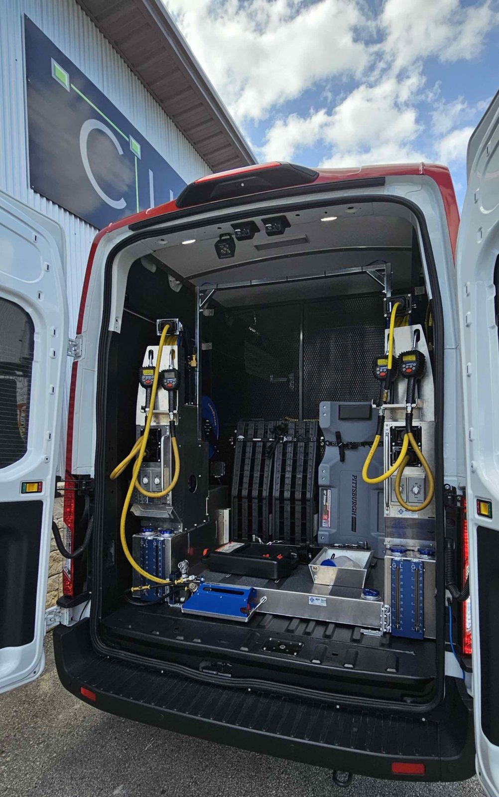 Auto service van with dual oiling stations and tools, doors open