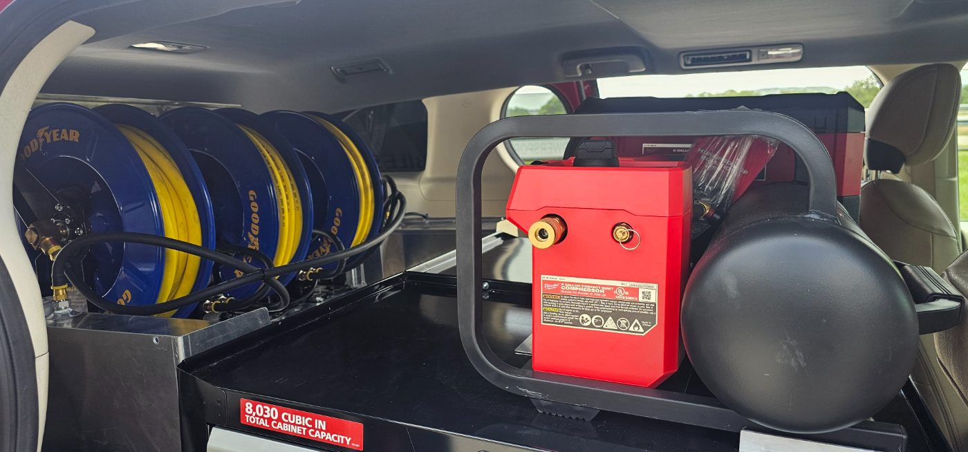 Milwaukee quiet compressor beside Goodyear hose reels
