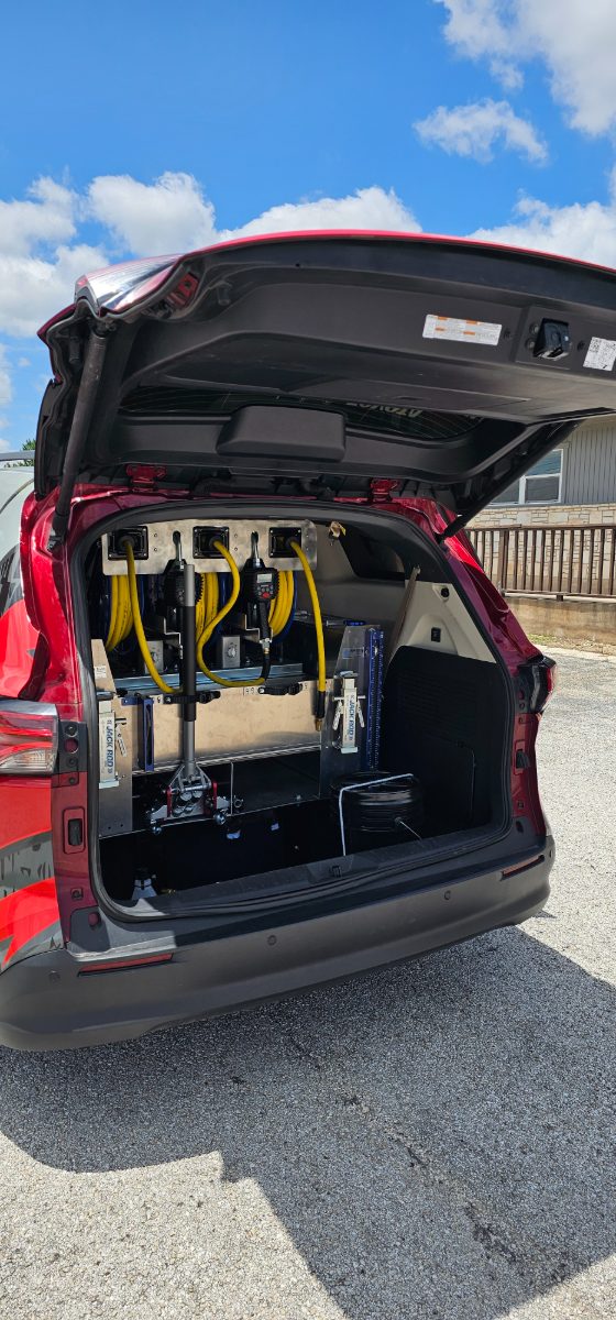 Full rear-hatch view of the mobile service build — oiling stations, jacks and storage